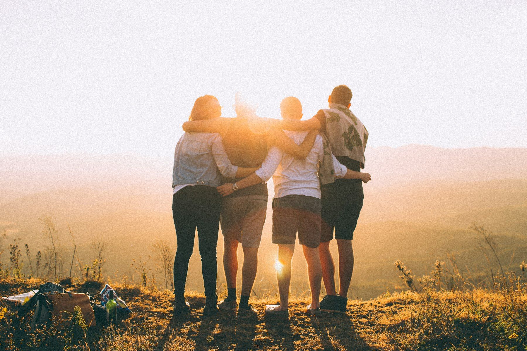 Friends arm in arm watching the sunset