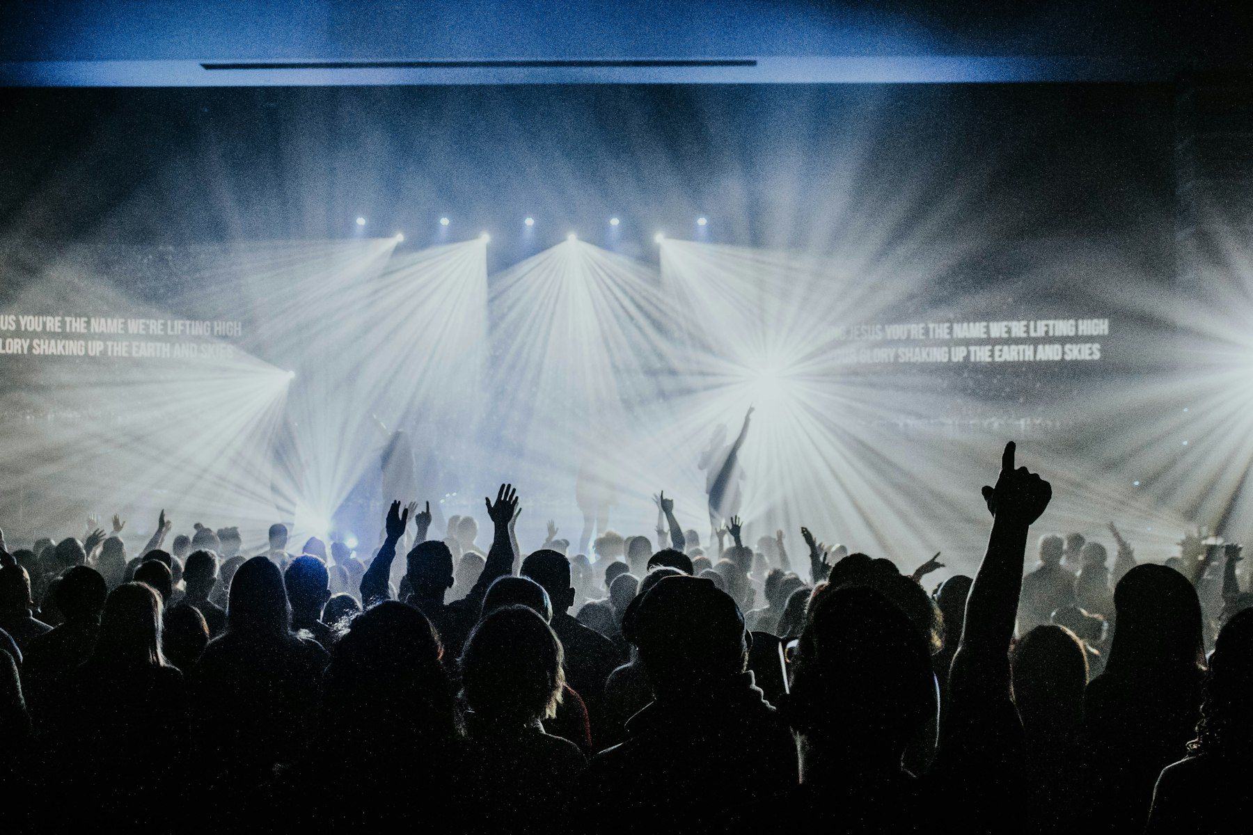 A room full of people worshipping together
